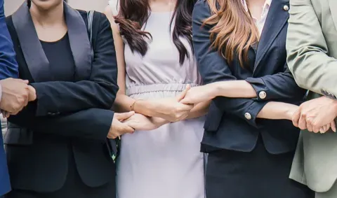 people with their hands intertwined