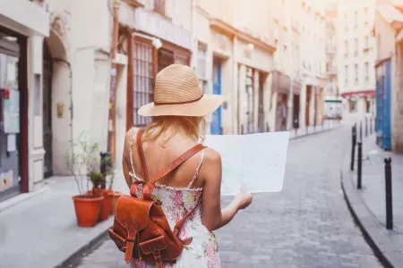 Woman looks at map on street