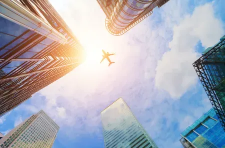 Plane flying over some skyscrapers